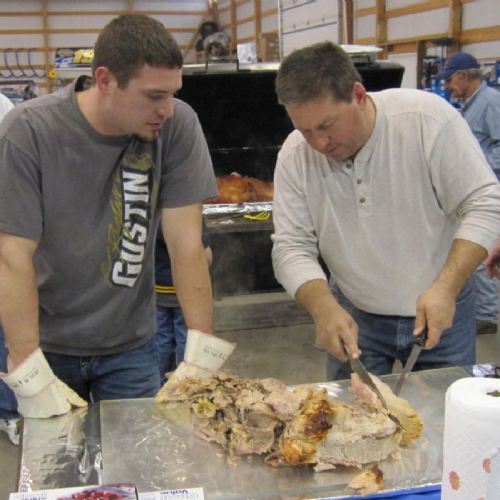 Dennis (our Hog Roasting Master) schools Joe Bob on the art of cutting and serving.